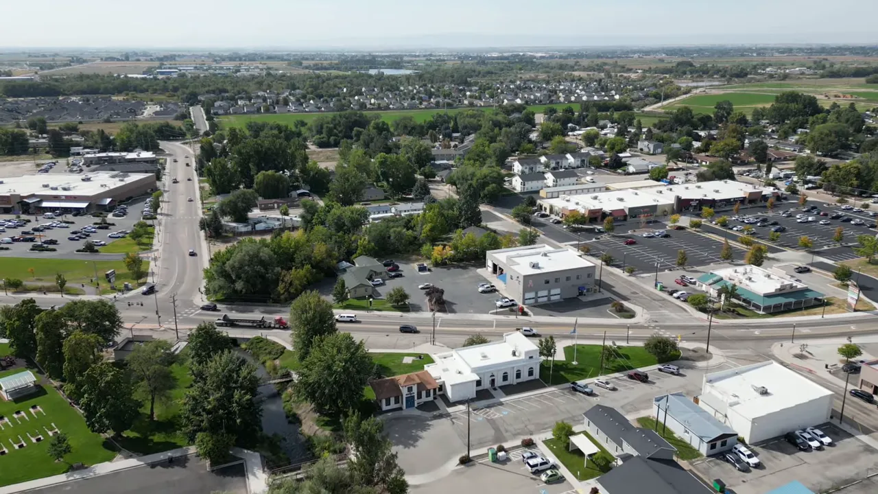Aerial aerial view of a town intersection with neighborhoods and shopping areas