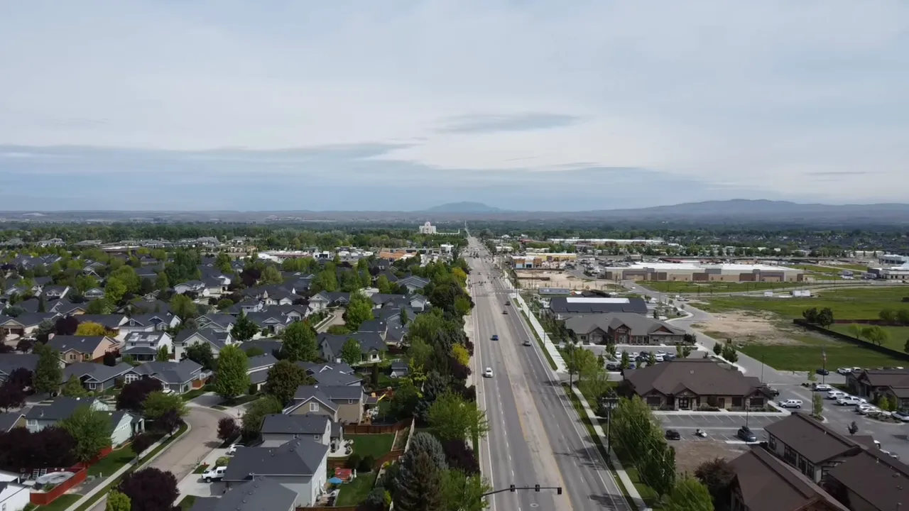 Aerial view of Meridian, Idaho showing a main road, neighborhoods, and nearby commercial areas