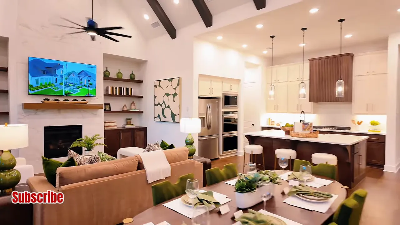 Open living room dining area and kitchen with tall windows ceiling beams and fireplace