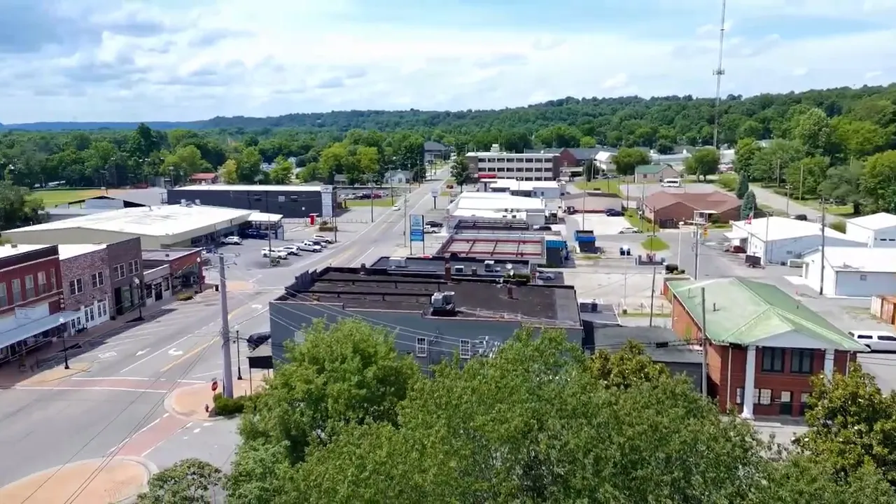 Aerial view of Ashland City downtown streets and buildings with trees in the distance
