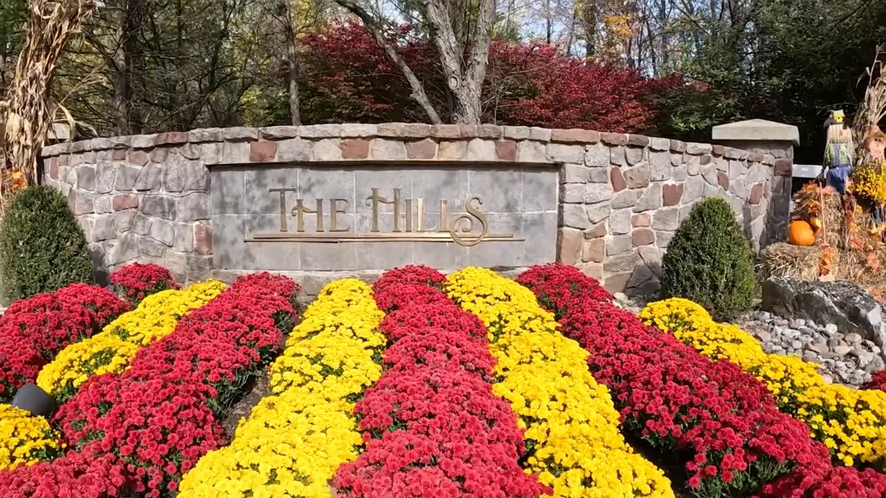 The Hills sign surrounded by seasonal flowers and landscaping