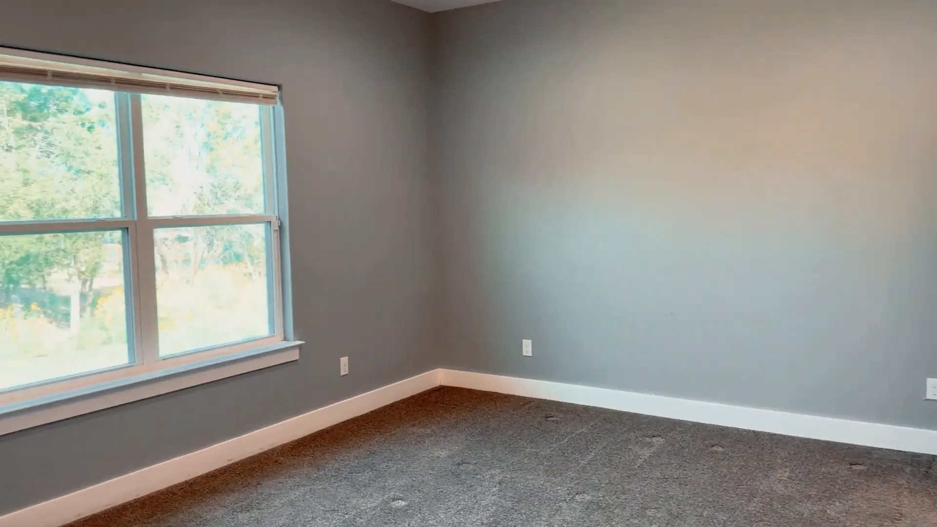 Master bedroom with bright lighting and large windows
