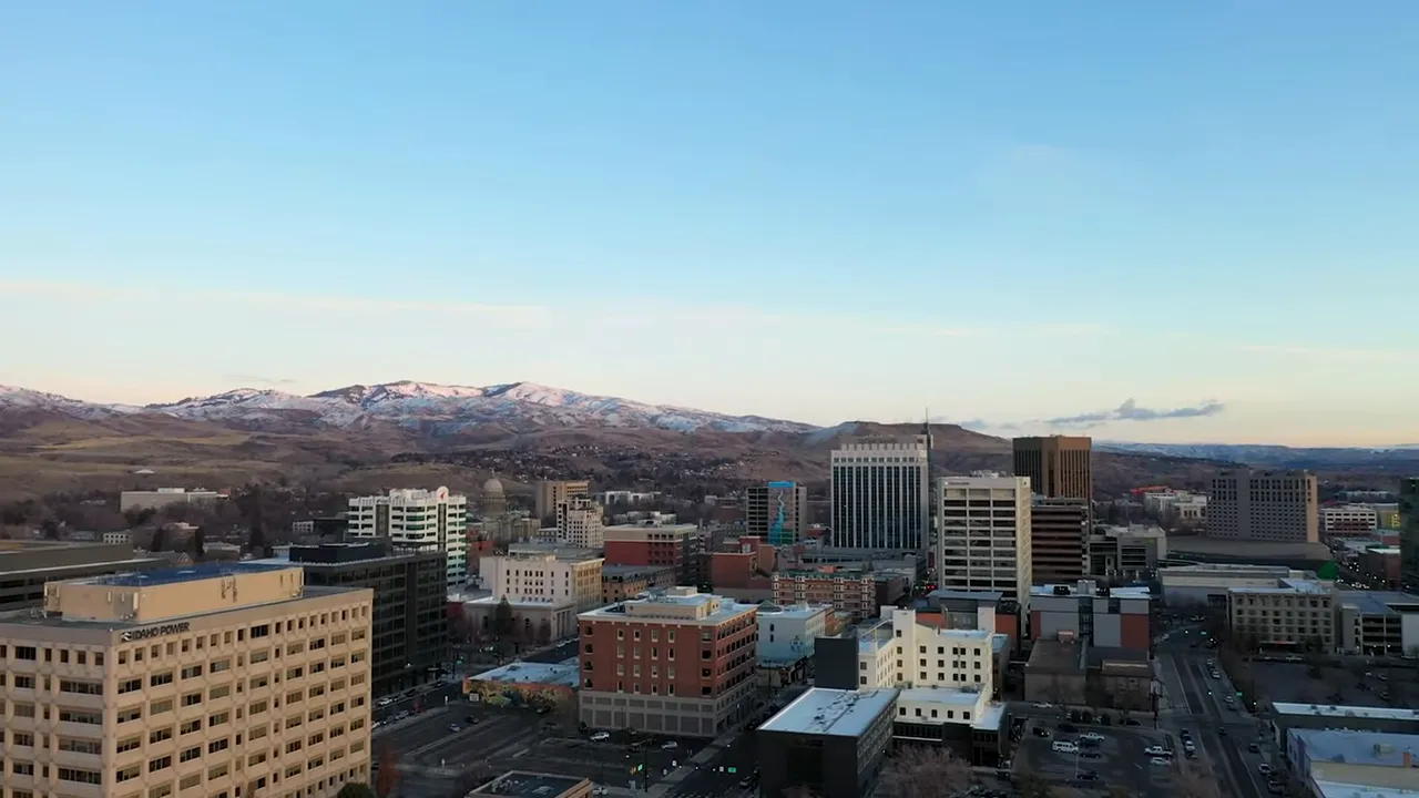 Aerial view of downtown Boise with city buildings and foothills