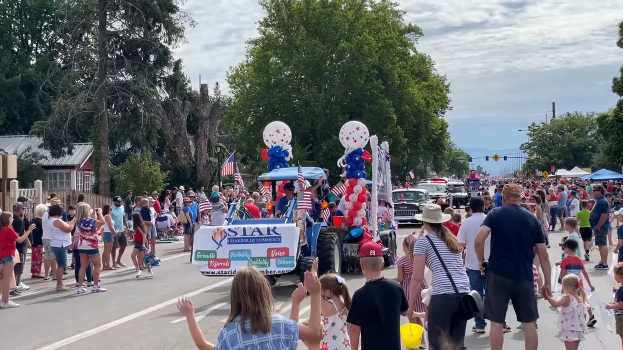 Fourth of July parade on Main Street with community watching