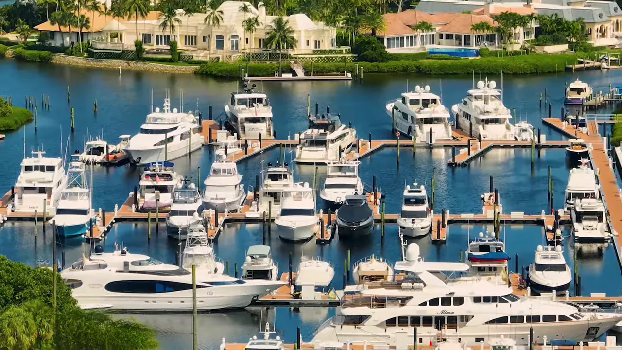 Marina filled with yachts and waterfront homes at Admirals Cove