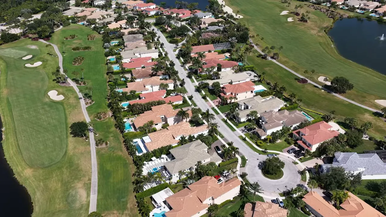 Aerial view of homes beside fairways and lakes at Jupiter Country Club