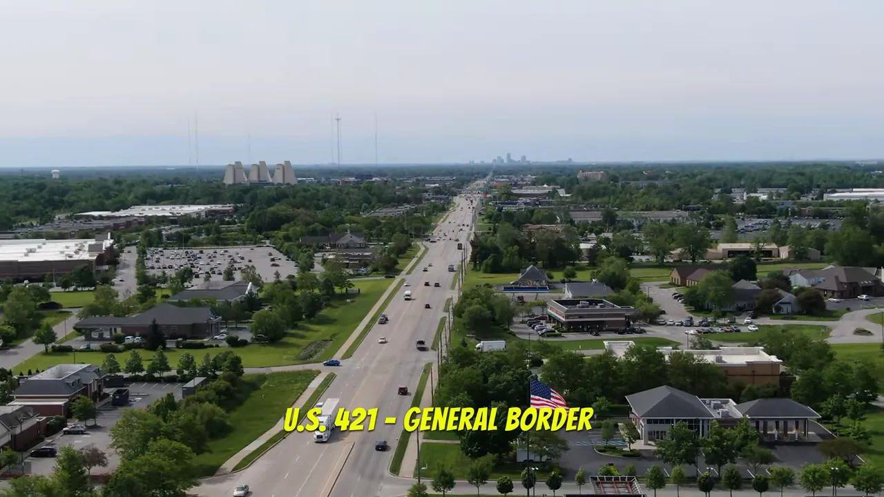 Aerial view of U S 421 with yellow text identifying the Carmel Zionsville general border