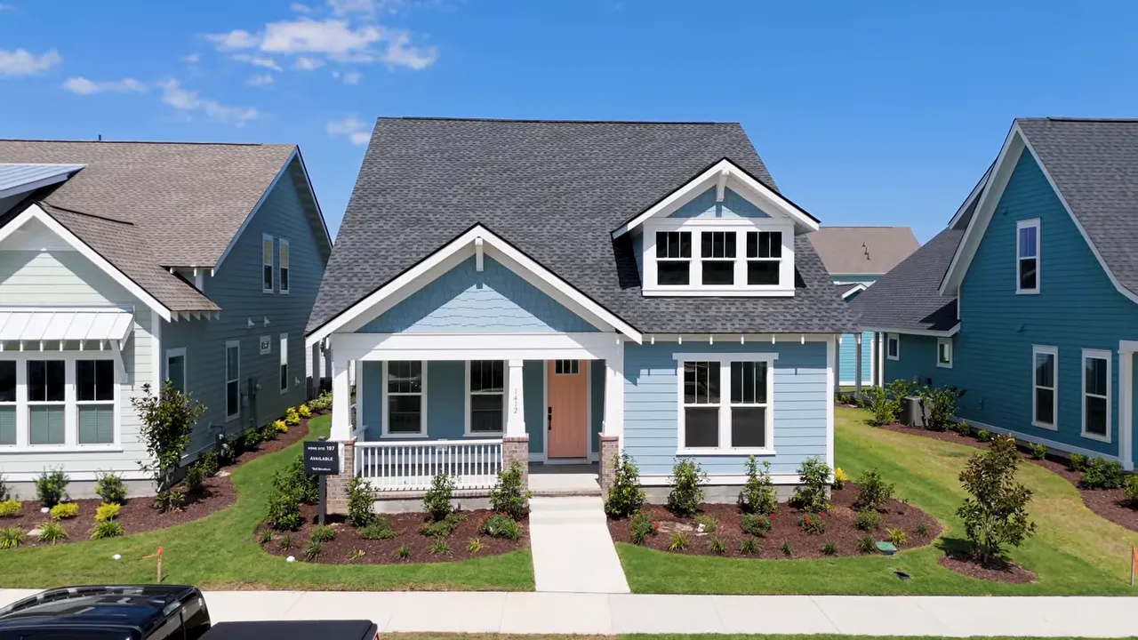 Row of colorful coastal style homes with front porches and sidewalks