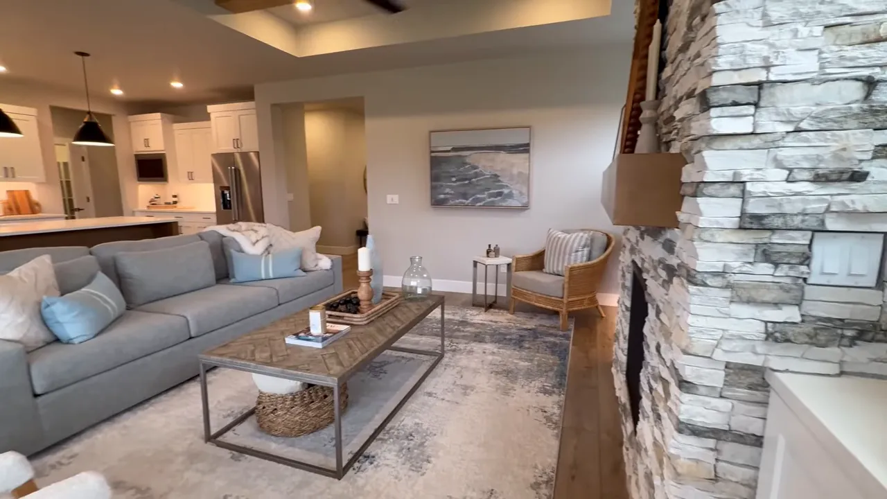 Bright open living room interior with fireplace and seating at a Mark’s Place at Tofte Farms home in Canby, Oregon