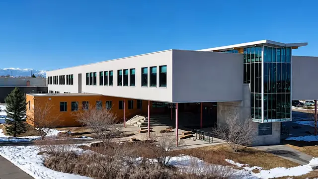 Modern school building with large windows and snow-covered grounds