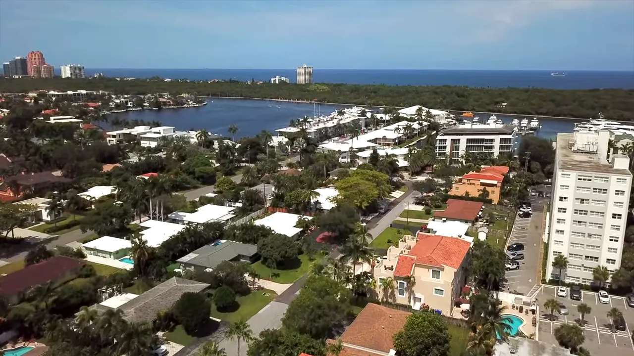 Aerial view of Coral Ridge neighborhood with marina, houses and ocean in the distance