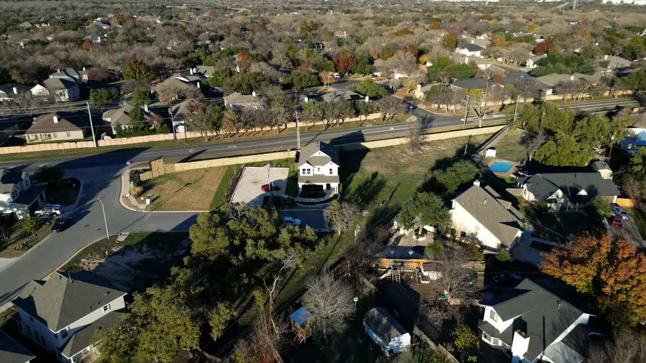 Aerial view of model home with orange text overlay showing base price 630000