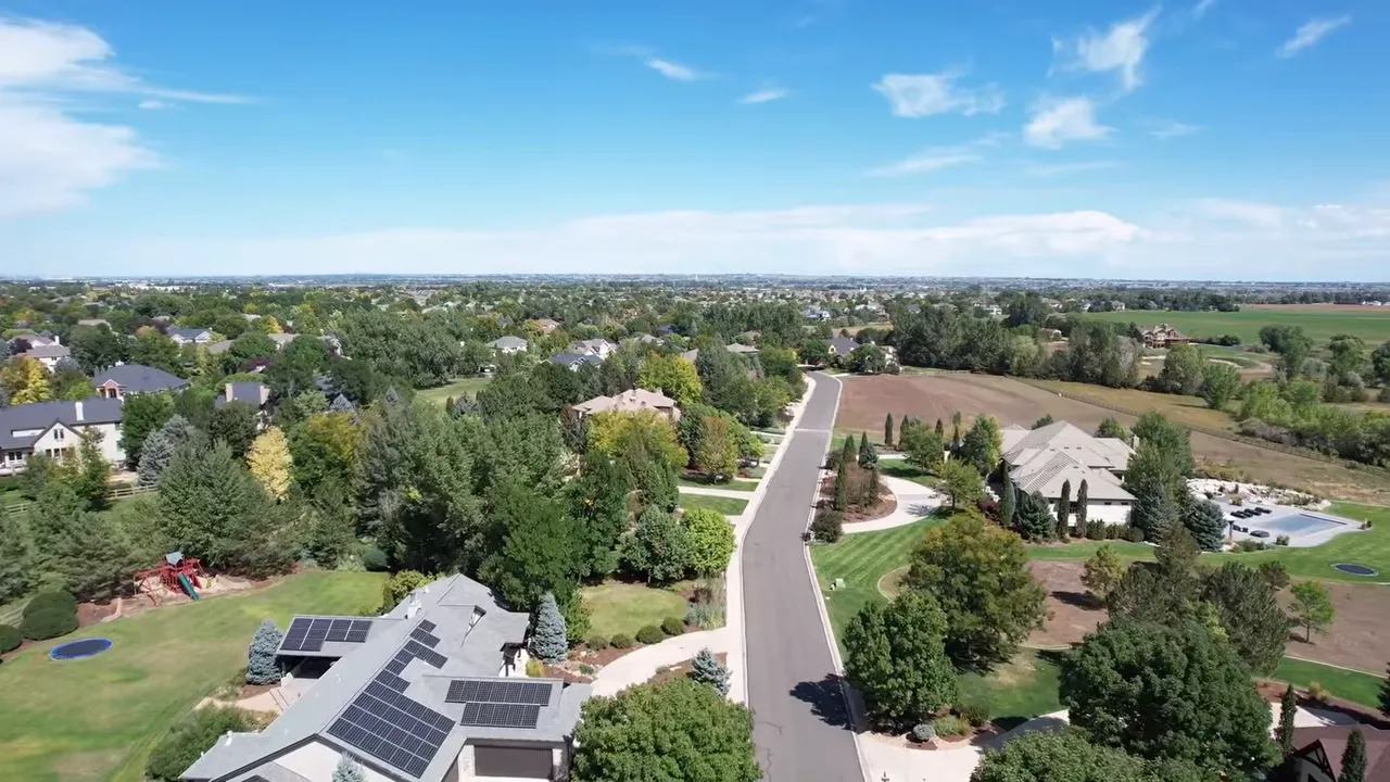 Aerial view of Fossil Lake Ranch in Fort Collins, CO showing homes, lawns, and a winding residential street