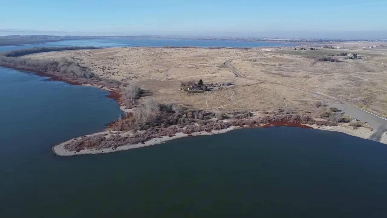 aerial view of lake shoreline with water and dry hills