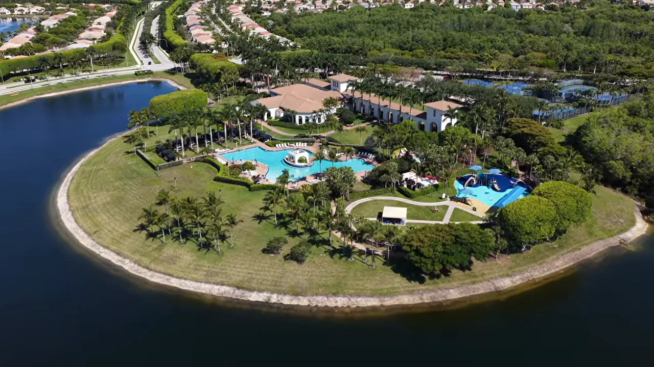 Aerial view of a Wellington Florida gated neighborhood with lakeside homes and resort-style pools