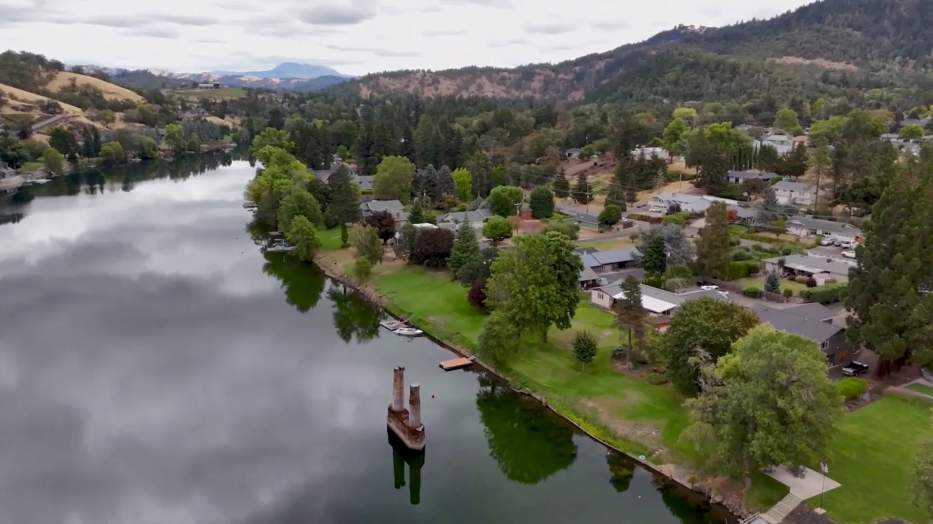 Umpqua River flowing through Roseburg with green hills