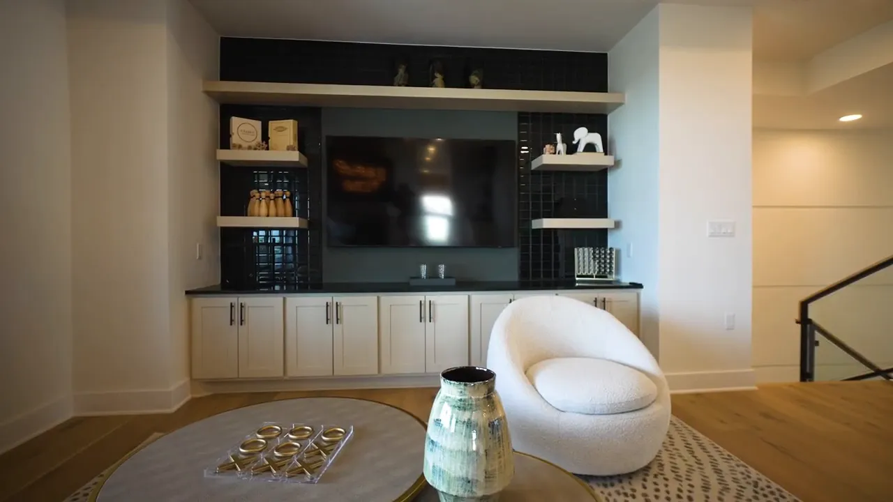 Upstairs game room with built in cabinet wall and seating area