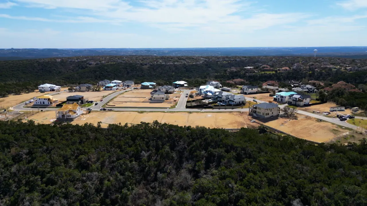 Aerial view of luxury homes surrounded by wooded hills