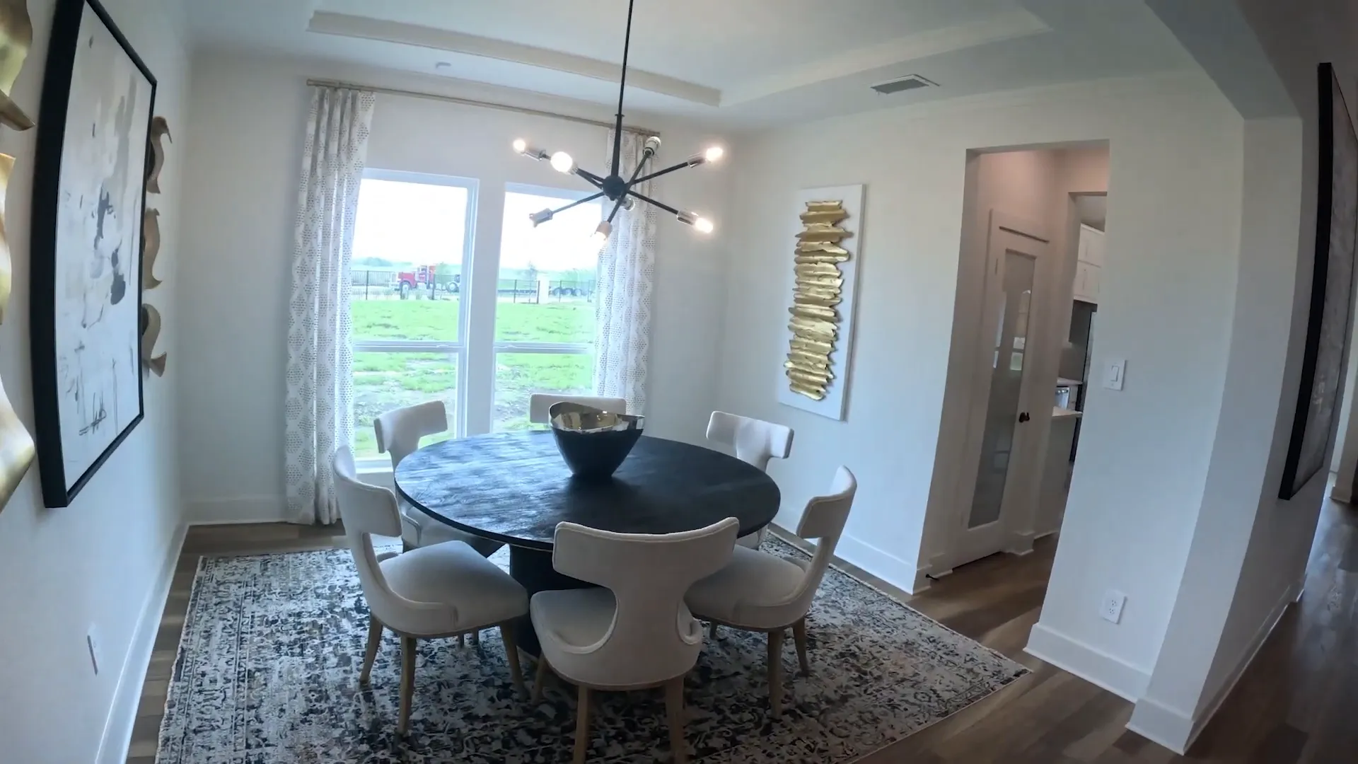 Formal dining room beside curved staircase