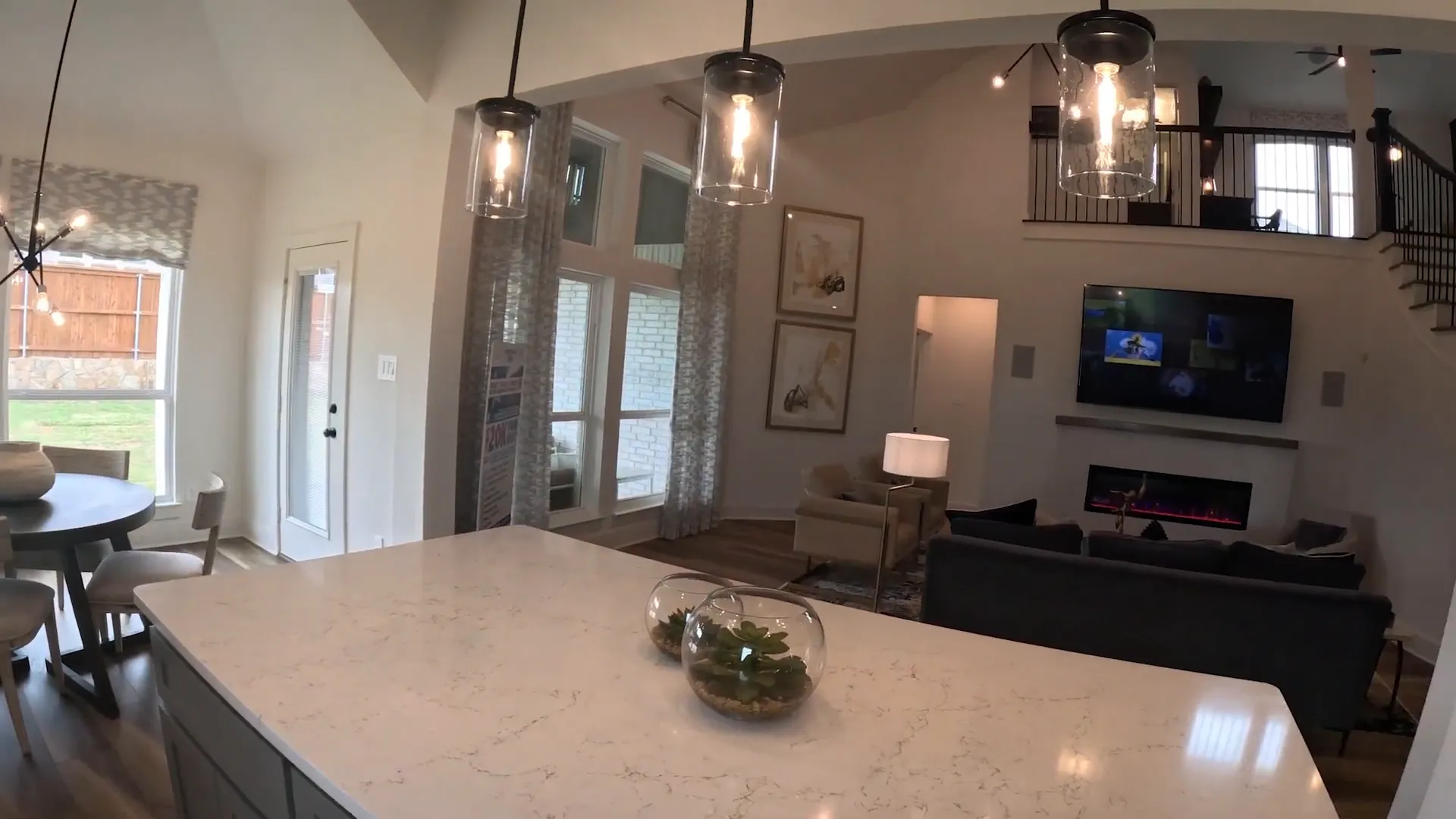 Large kitchen island opening to breakfast area and living room