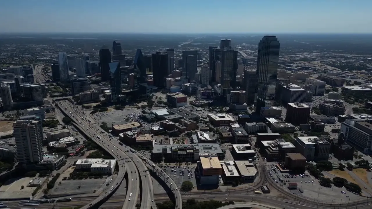Aerial skyline of downtown Dallas with highways and surrounding neighborhoods