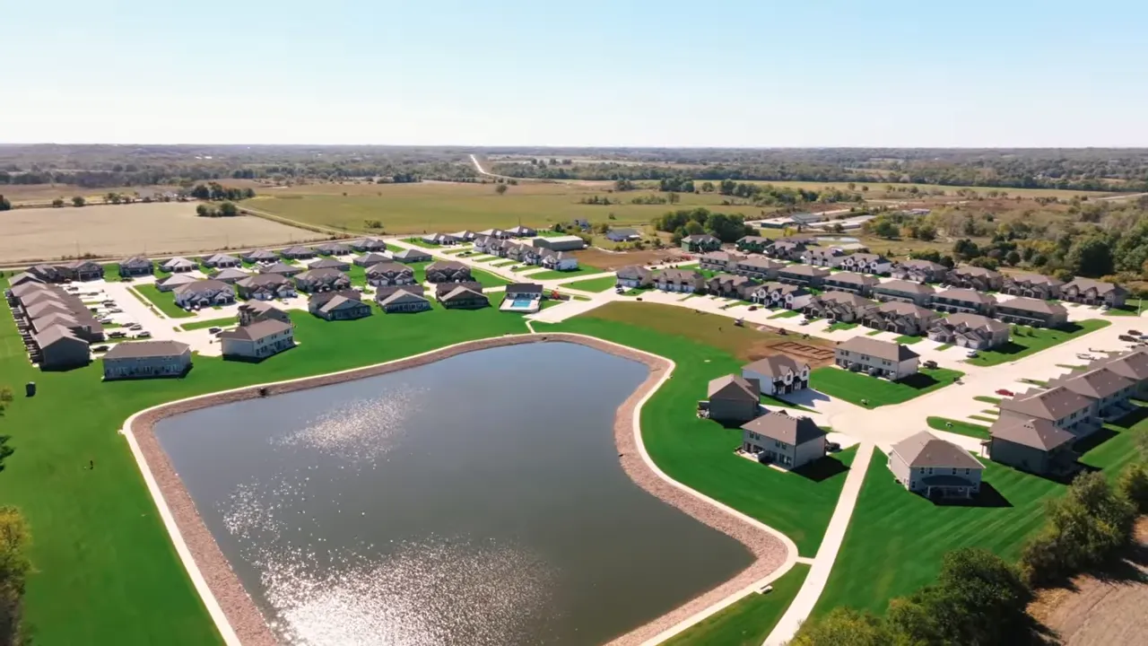 Clear aerial view of Bryson Lake neighborhood with central lake, sidewalks and surrounding houses.