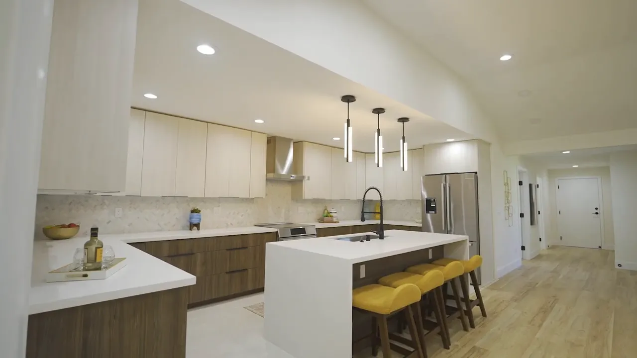 Kahala house gourmet kitchen with waterfall island and yellow bar stools