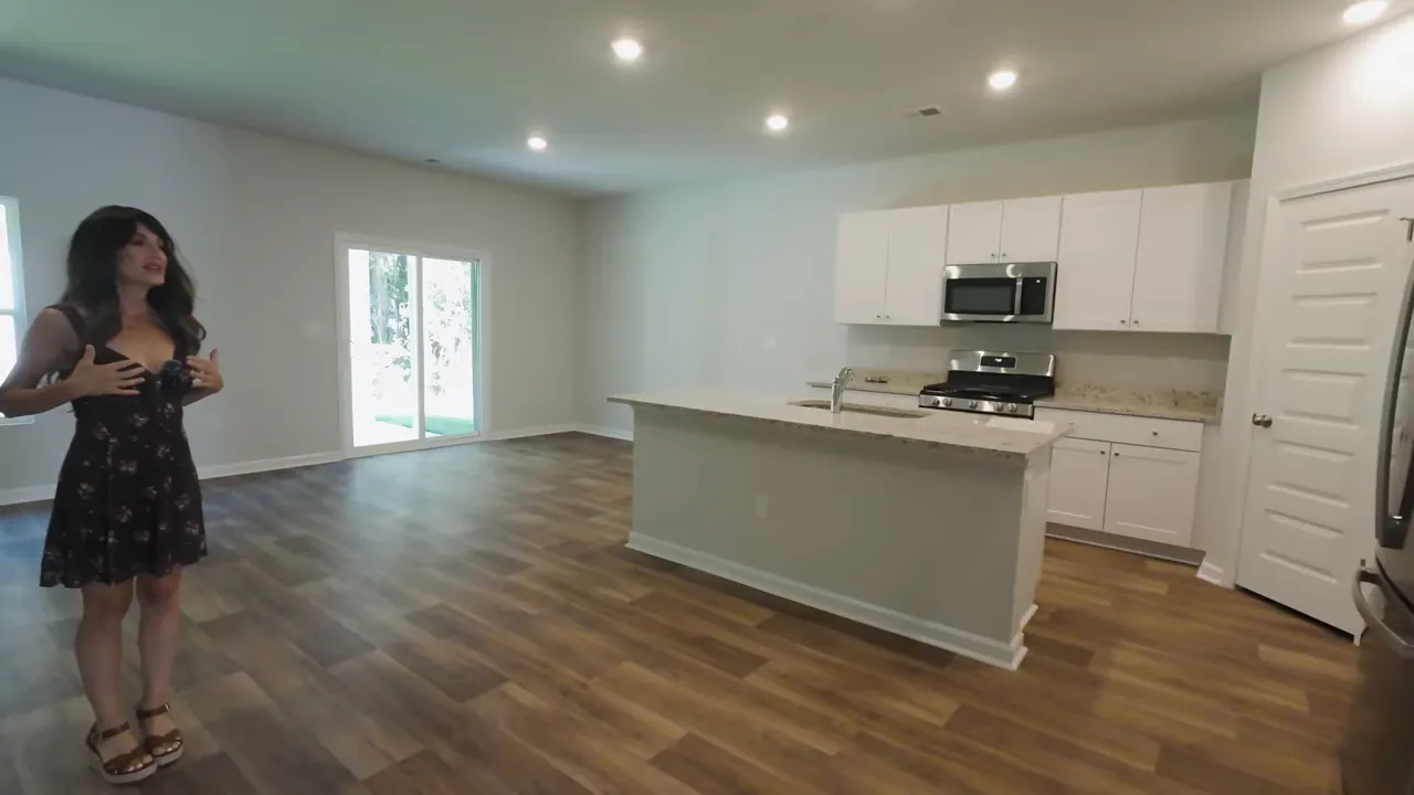 New construction kitchen with gas stove, microwave, and island seating in Little River SC home