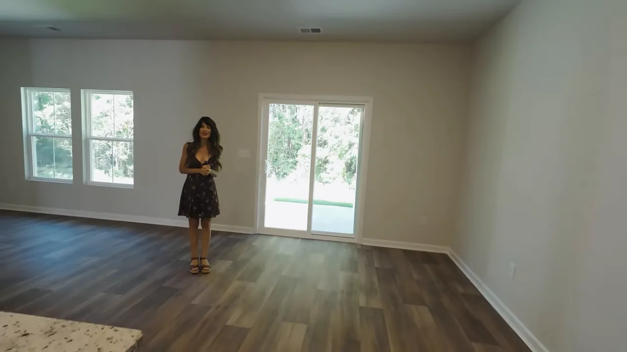 Primary bedroom interior in new construction Little River SC home with large windows and wood-look flooring