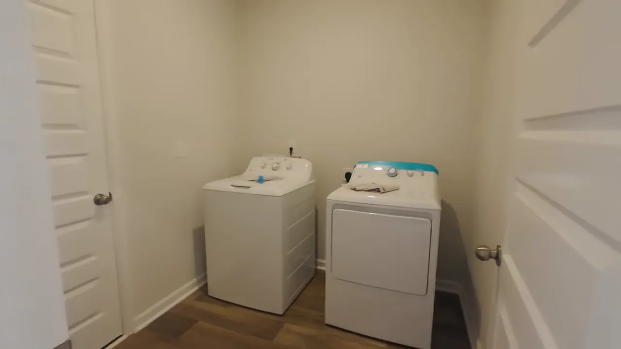 Laundry room in a new construction home with washer and dryer