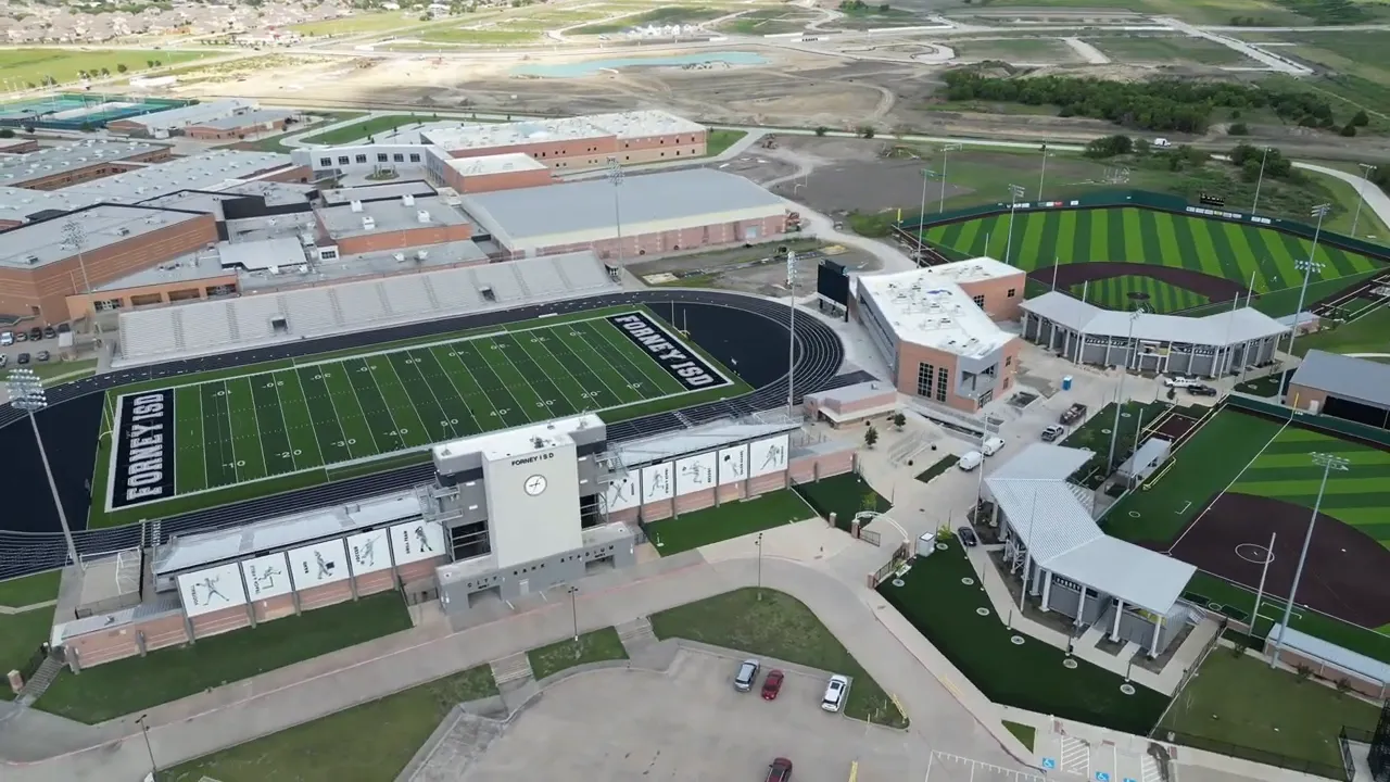 Aerial view of Forney ISD sports fields stadium and school buildings