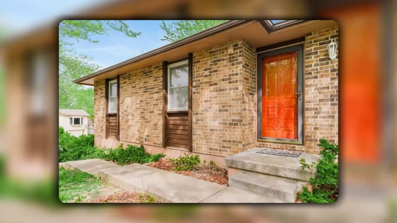 Front exterior of a brick home in Claymont Warrensburg, MO with an orange entry door and landscaping