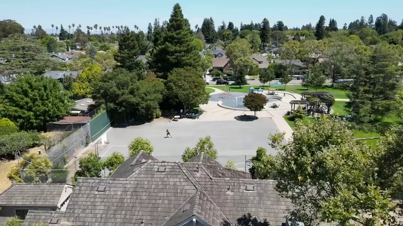 Aerial view of neighborhood park showing playground, courts, picnic area and surrounding homes
