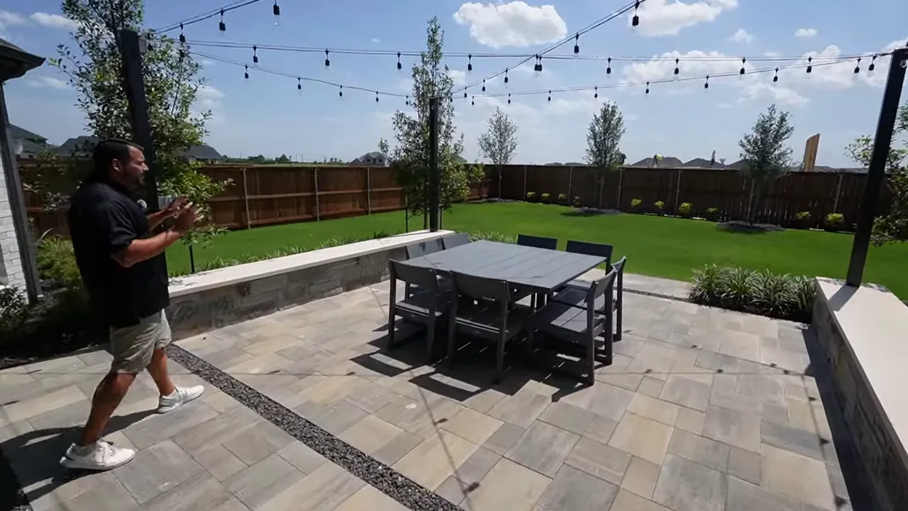 Extended covered patio with ceiling fan and hardscaping
