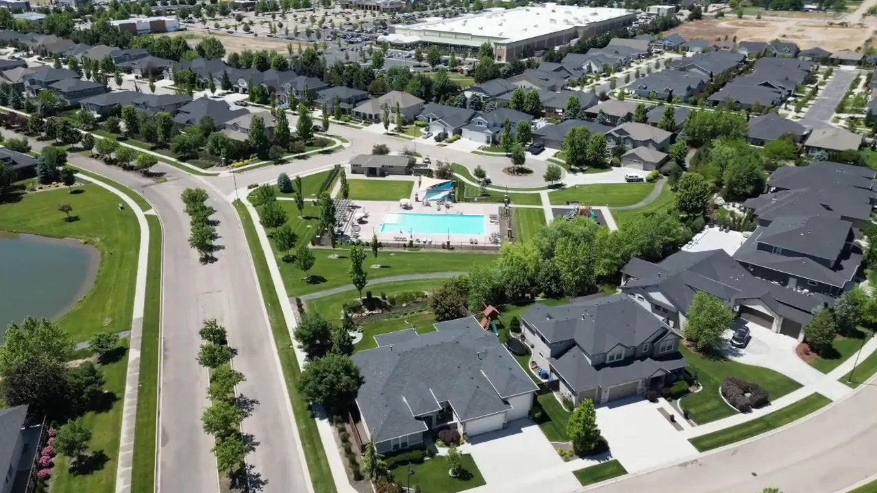 aerial view of a neighborhood clubhouse and pool surrounded by homes