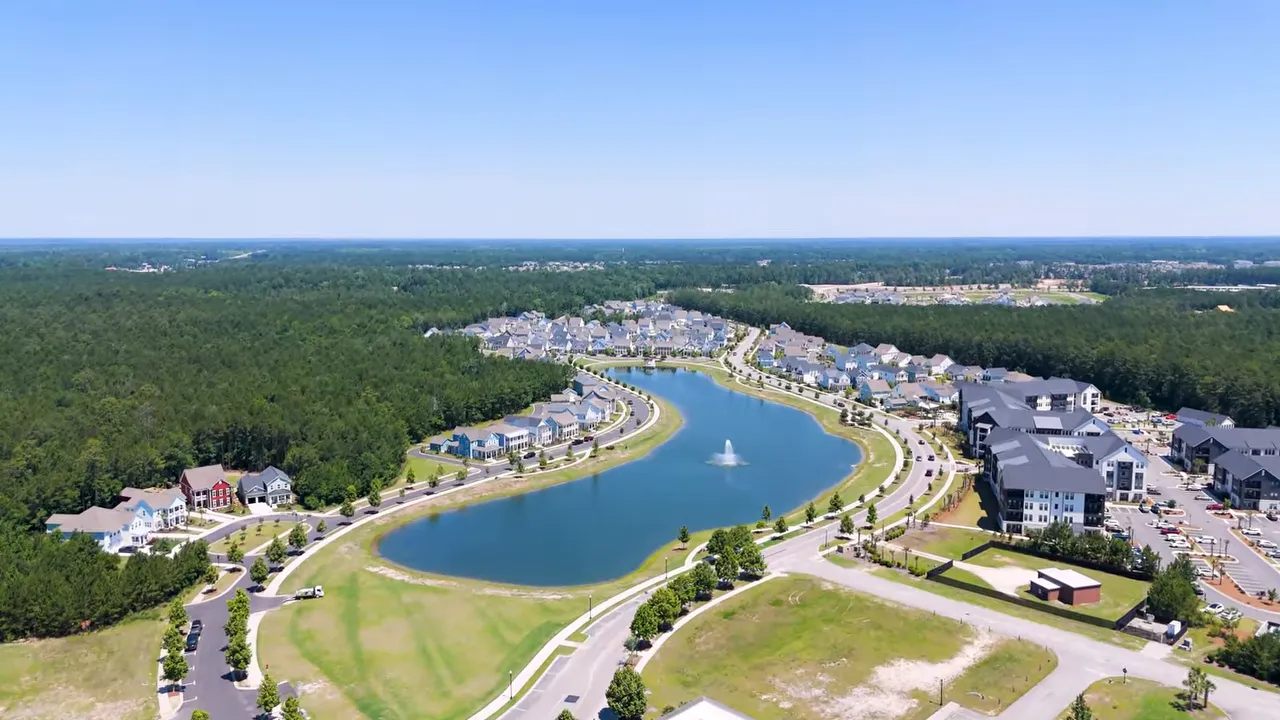 Aerial view of homes surrounding a curved lake