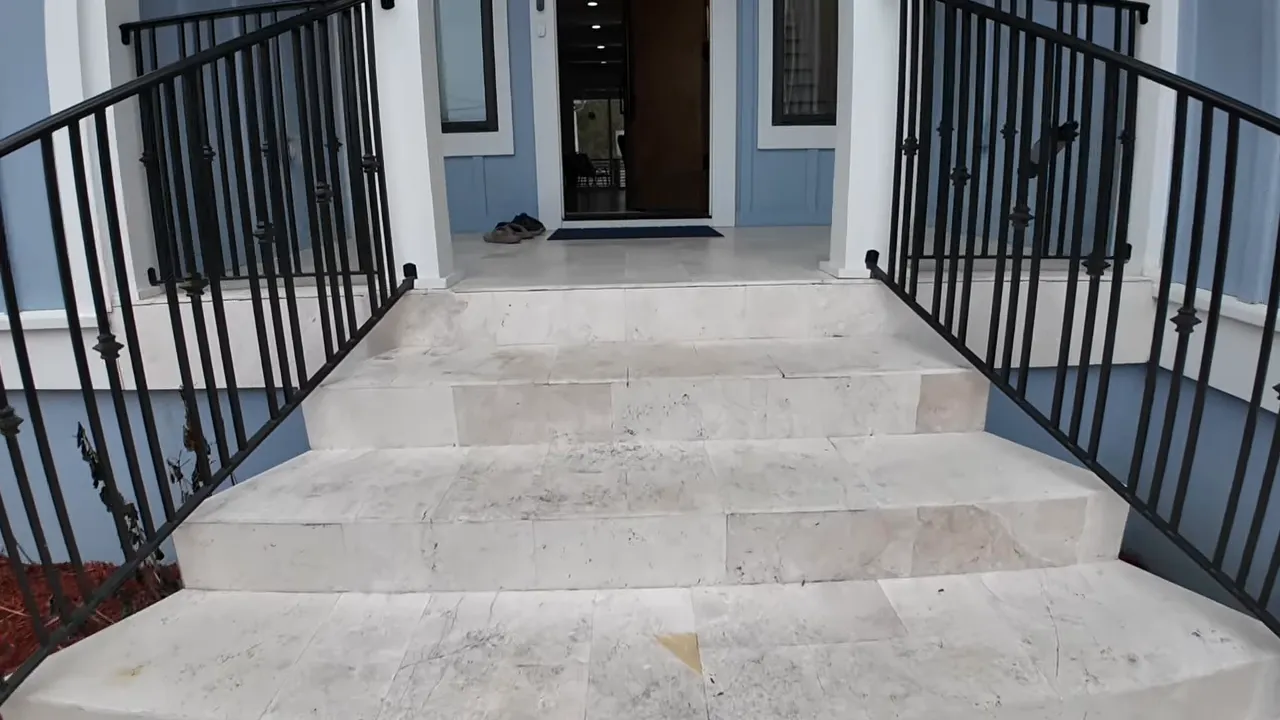 Porch entry walkway inside a Summerville custom home with black railing