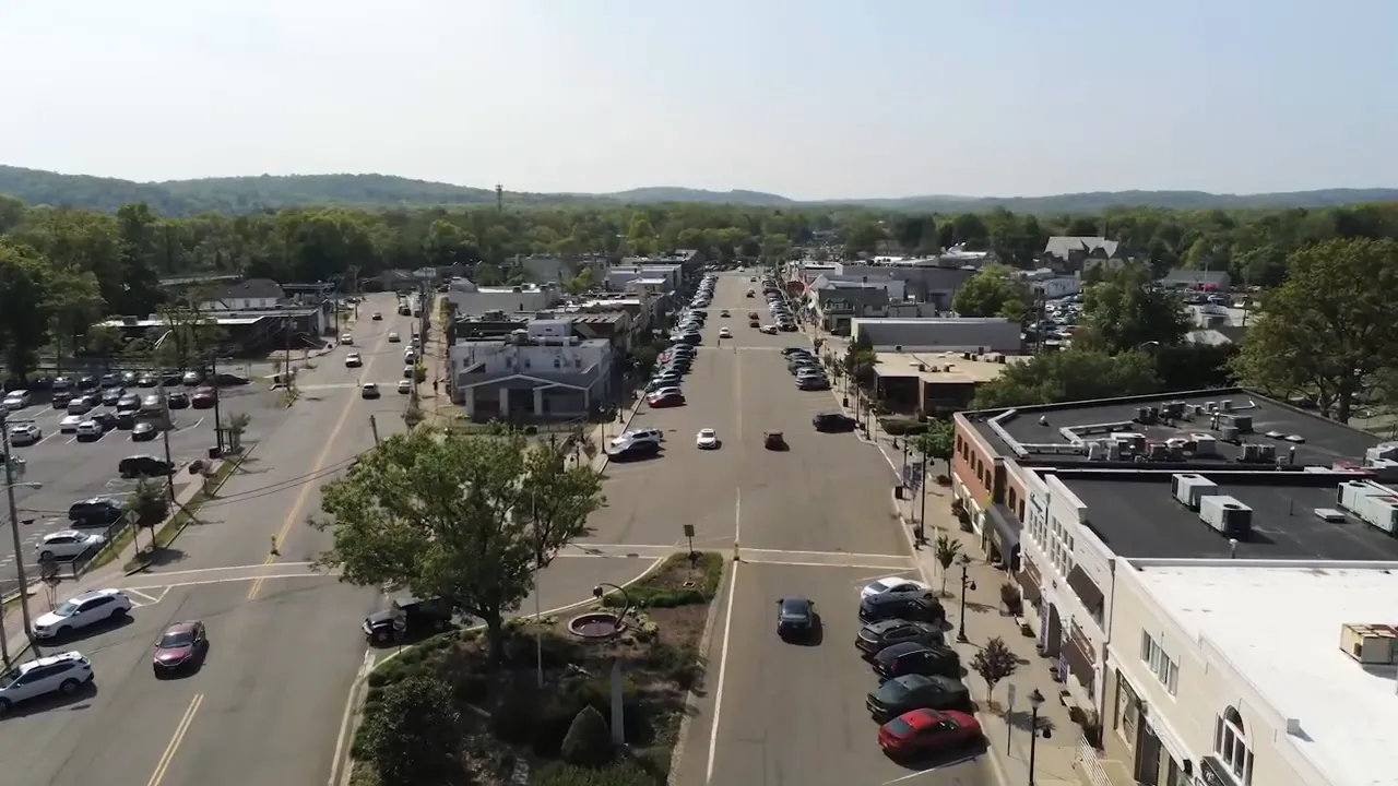 aerial view of a downtown corridor with on screen text coffee shops
