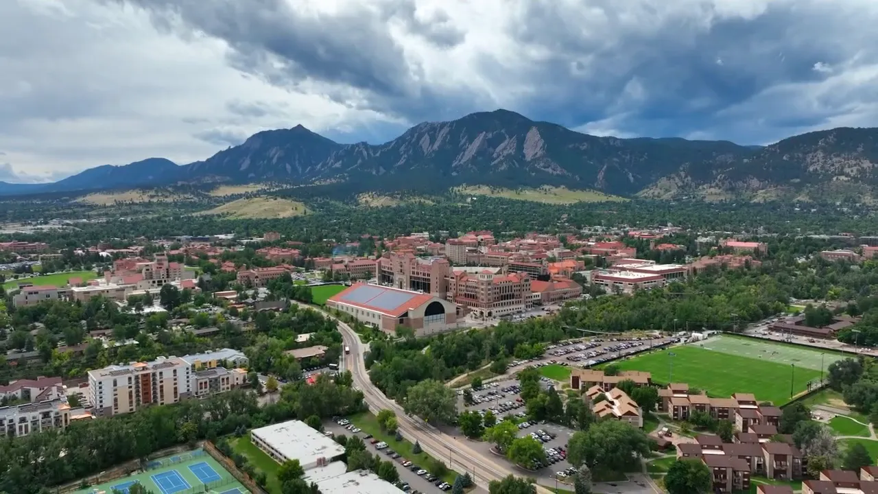 Aerial view of Boulder with Flatirons mountains behind the city