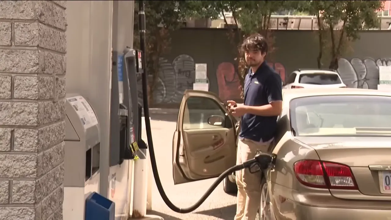 Man pumping gas beside beige sedan at station