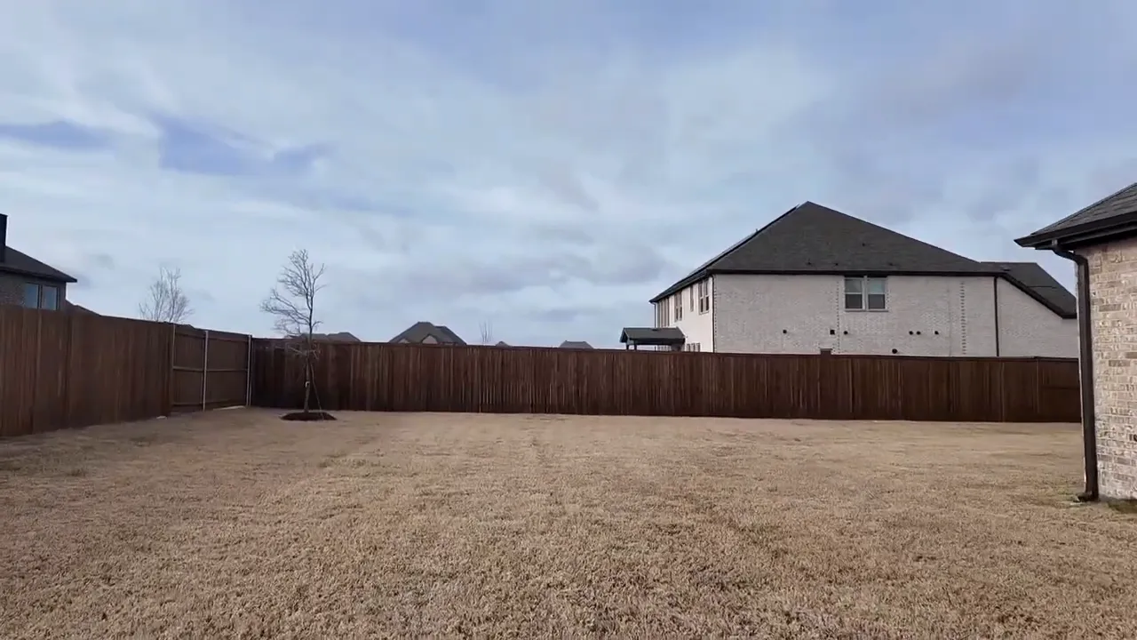 Large fenced backyard with open lawn in new homes near Dallas Texas