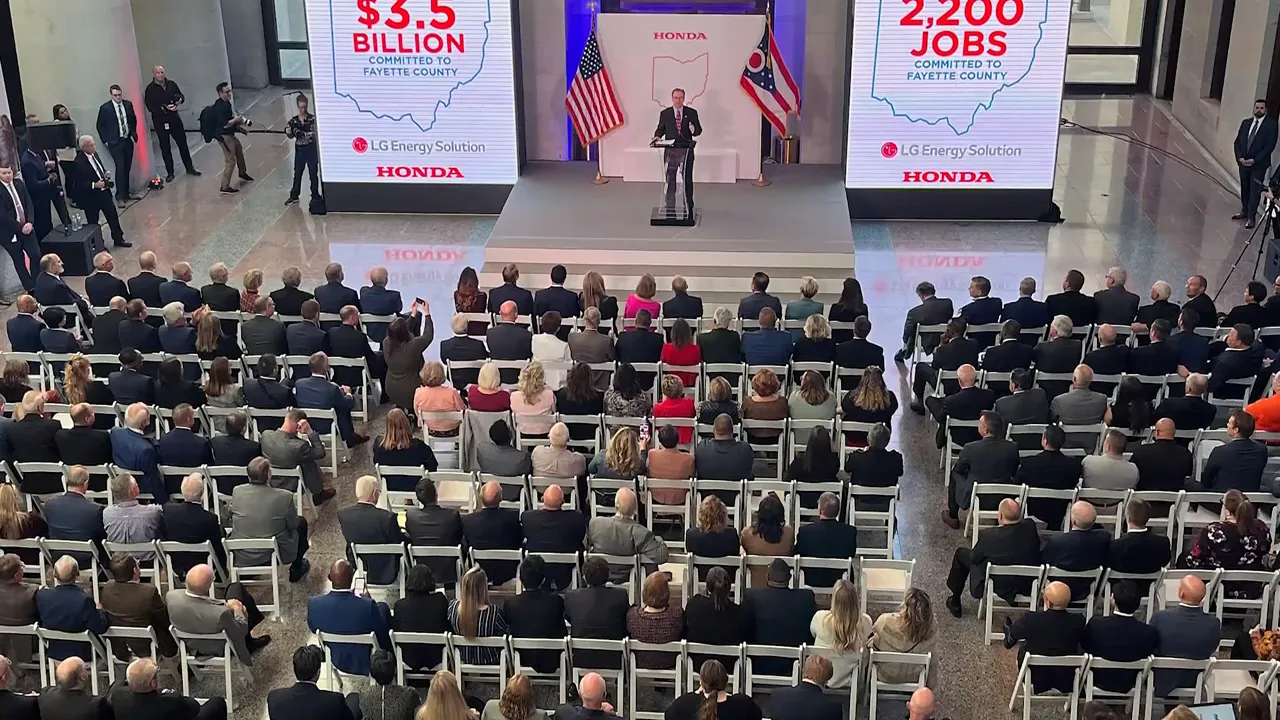 Honda event stage with signs reading 3.5 billion and 2200 jobs