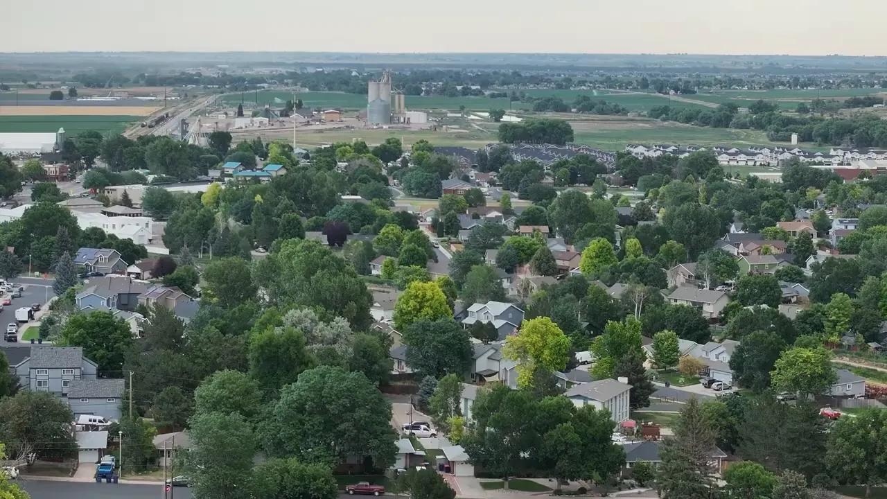 Aerial view of tree-lined Johnstown neighborhoods and open farmland