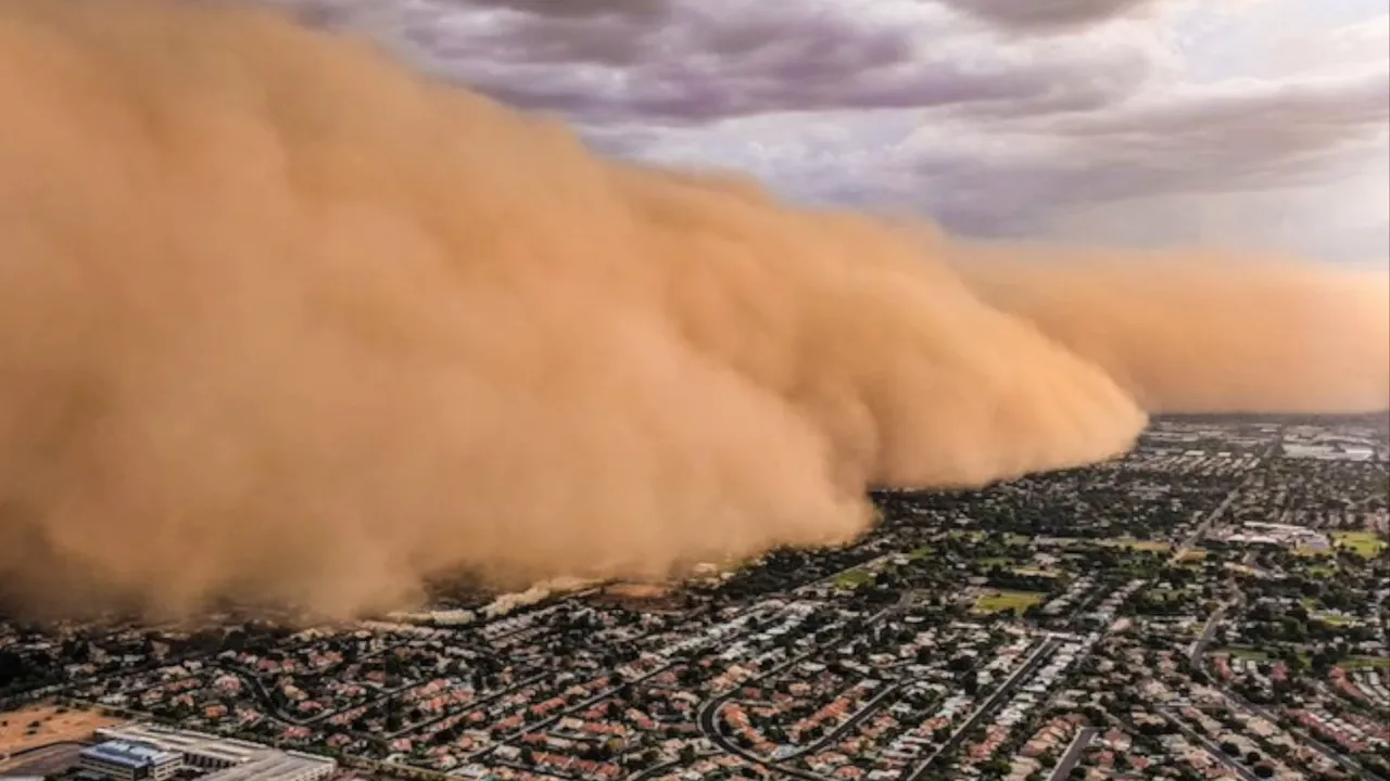 Massive wall of dust moving across a city during a haboob storm