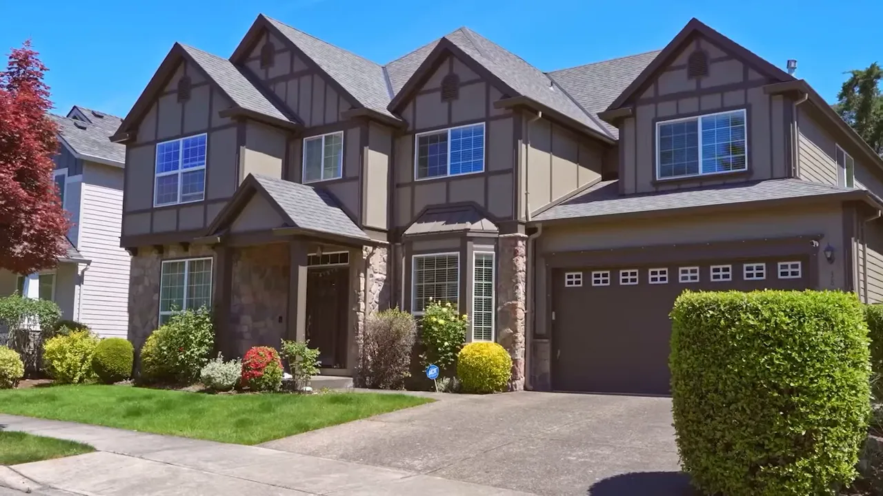 Large traditional house with landscaped yard and three-car garage