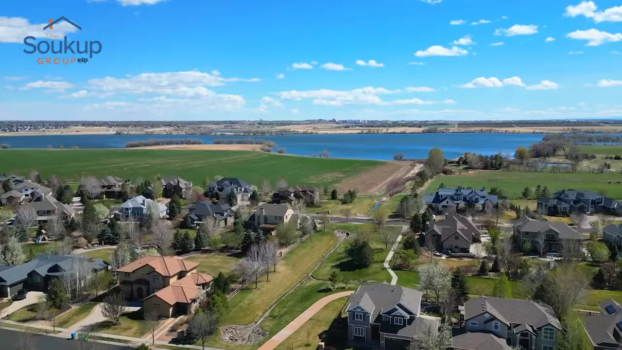 Aerial view of suburban homes beside open fields