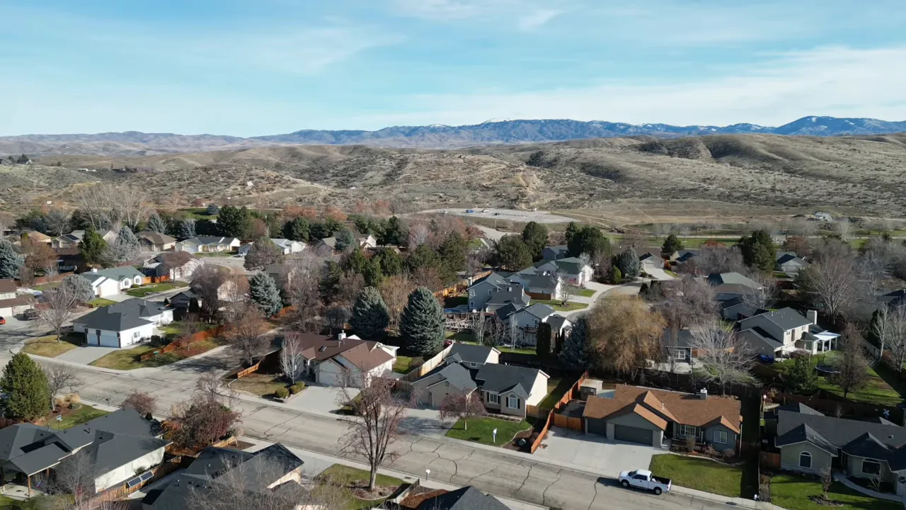 Aerial drone view of a Boise-area neighborhood with surrounding hills and homes