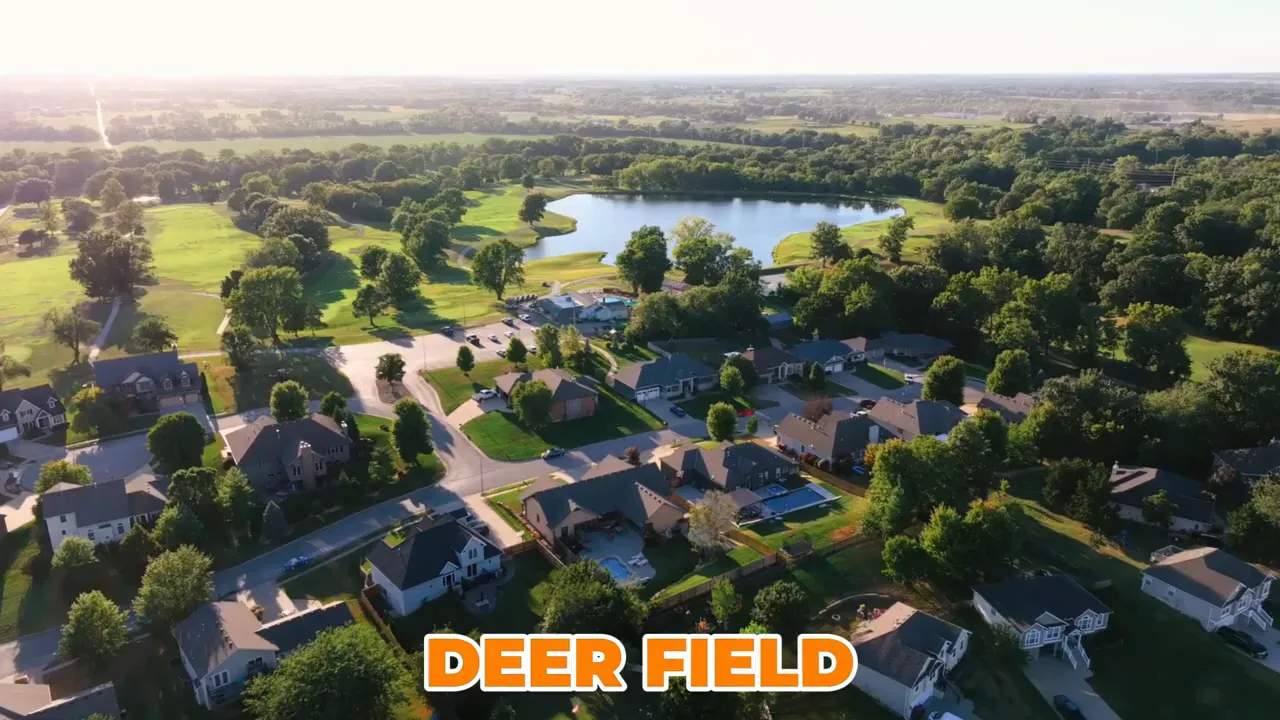 Aerial view of Deerfield neighborhood with pond and surrounding green space in Warrensburg, Missouri