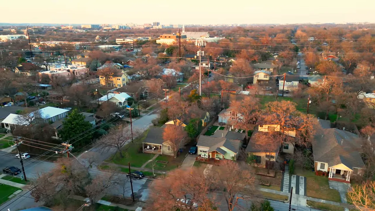 Aerial view of residential streets with houses and autumn-colored trees