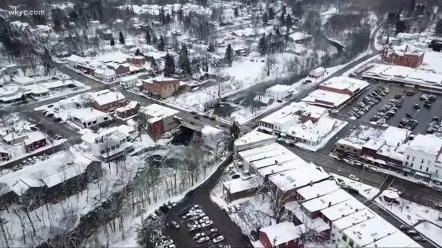 Snow covered neighborhood and roads seen from above